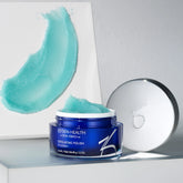 Blue jar of ZO Skin Health Exfoliating Polish with a white applicator on a gray background
